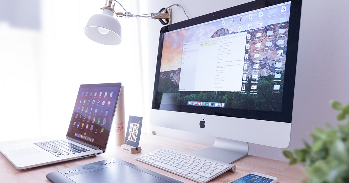 A Laptop and a Desktop on a desk