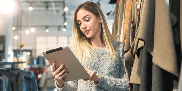 Person holding tablet in clothes shop - network security image